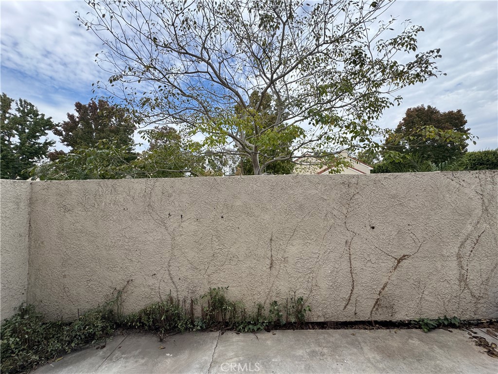 6 Columbia, Unit 2 Irvine, CA 92612 - Photo 23 of 25 front view of a stone house with large trees