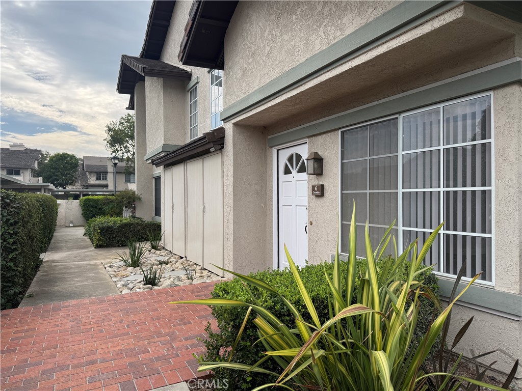6 Columbia, Unit 2 Irvine, CA 92612 - Photo 3 of 25 a view of a porch with potted plants and floor to ceiling window