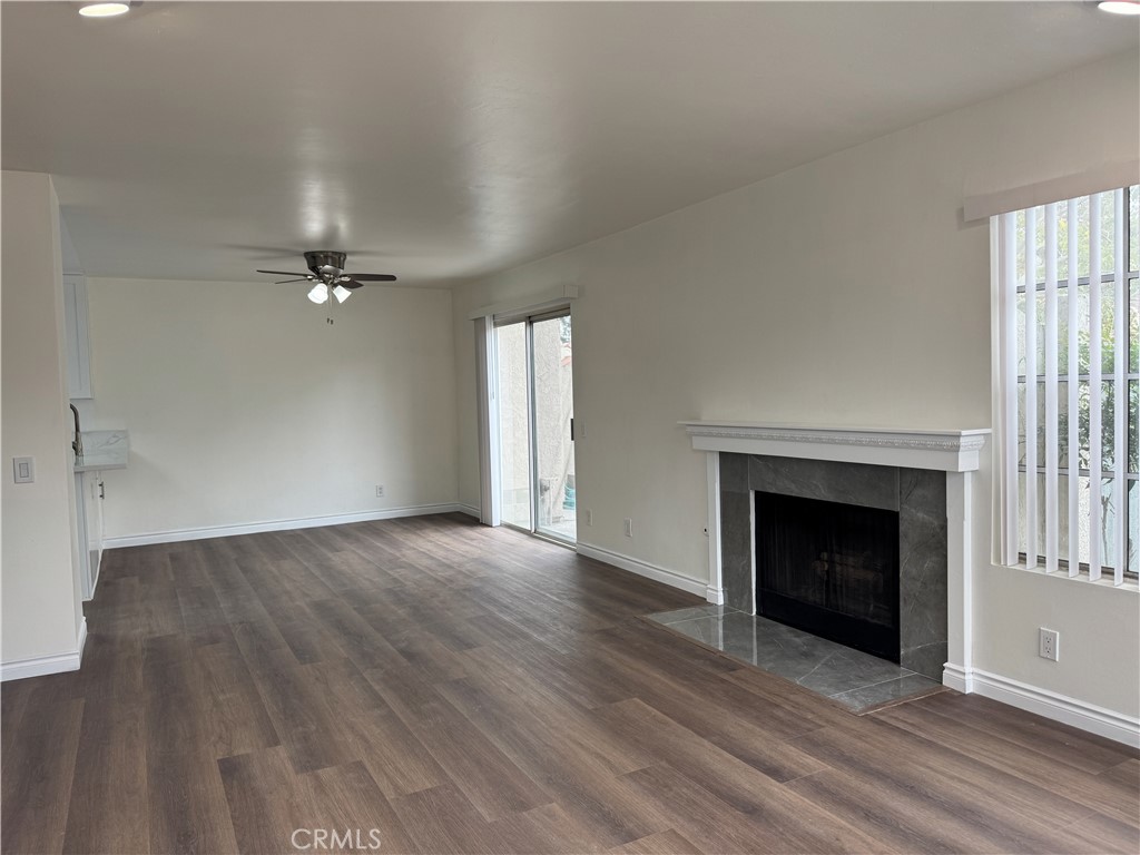 6 Columbia, Unit 2 Irvine, CA 92612 - Photo 7 of 25 an empty room with wooden floor fireplace and windows