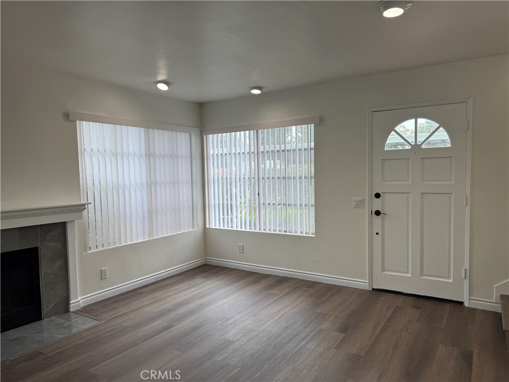 6 Columbia, Unit 2 Irvine, CA 92612 - Photo 8 of 25 an empty room with wooden floor cabinet and windows