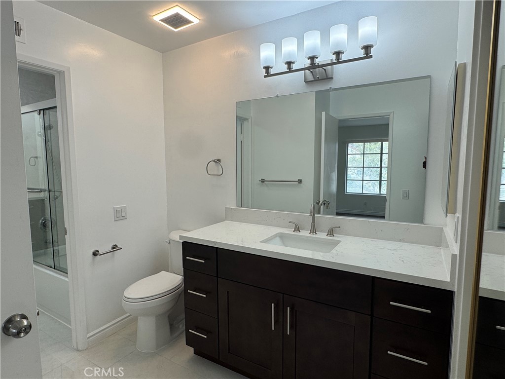 6 Columbia, Unit 2 Irvine, CA 92612 - Photo 9 of 25 a bathroom with a sink vanity toilet and shower