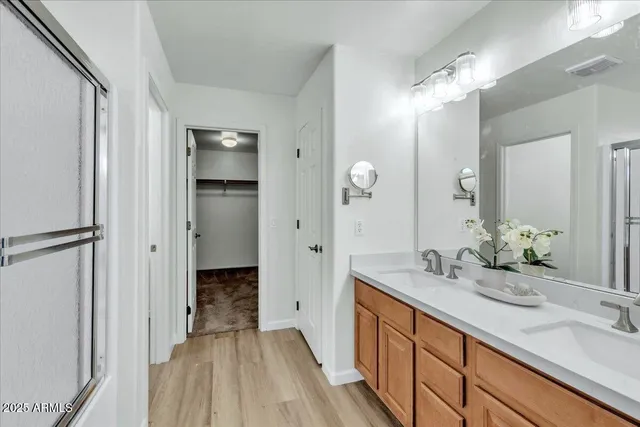 a spacious bathroom with a double vanity sink and a mirror