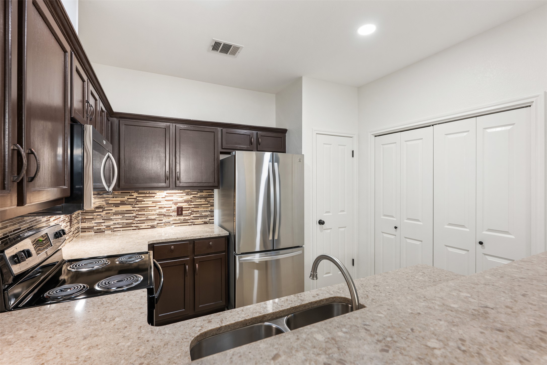 2429 A Curry Loop Round Rock, TX 78664 - Photo 24 of 28 a kitchen with stainless steel appliances granite countertop a refrigerator a stove and a sink
