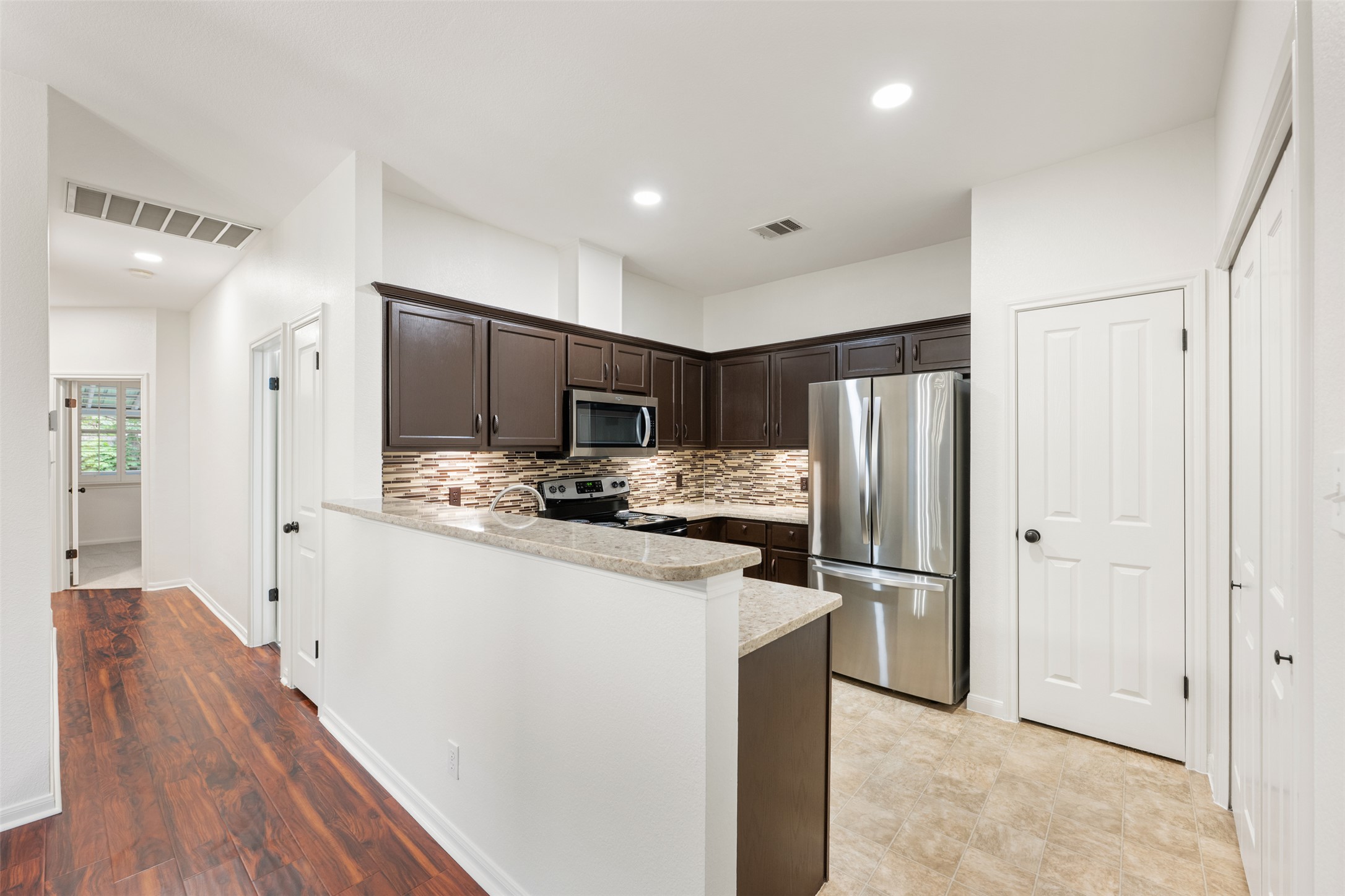 2429 A Curry Loop Round Rock, TX 78664 - Photo 25 of 28 a kitchen with stainless steel appliances a refrigerator and a stove top oven