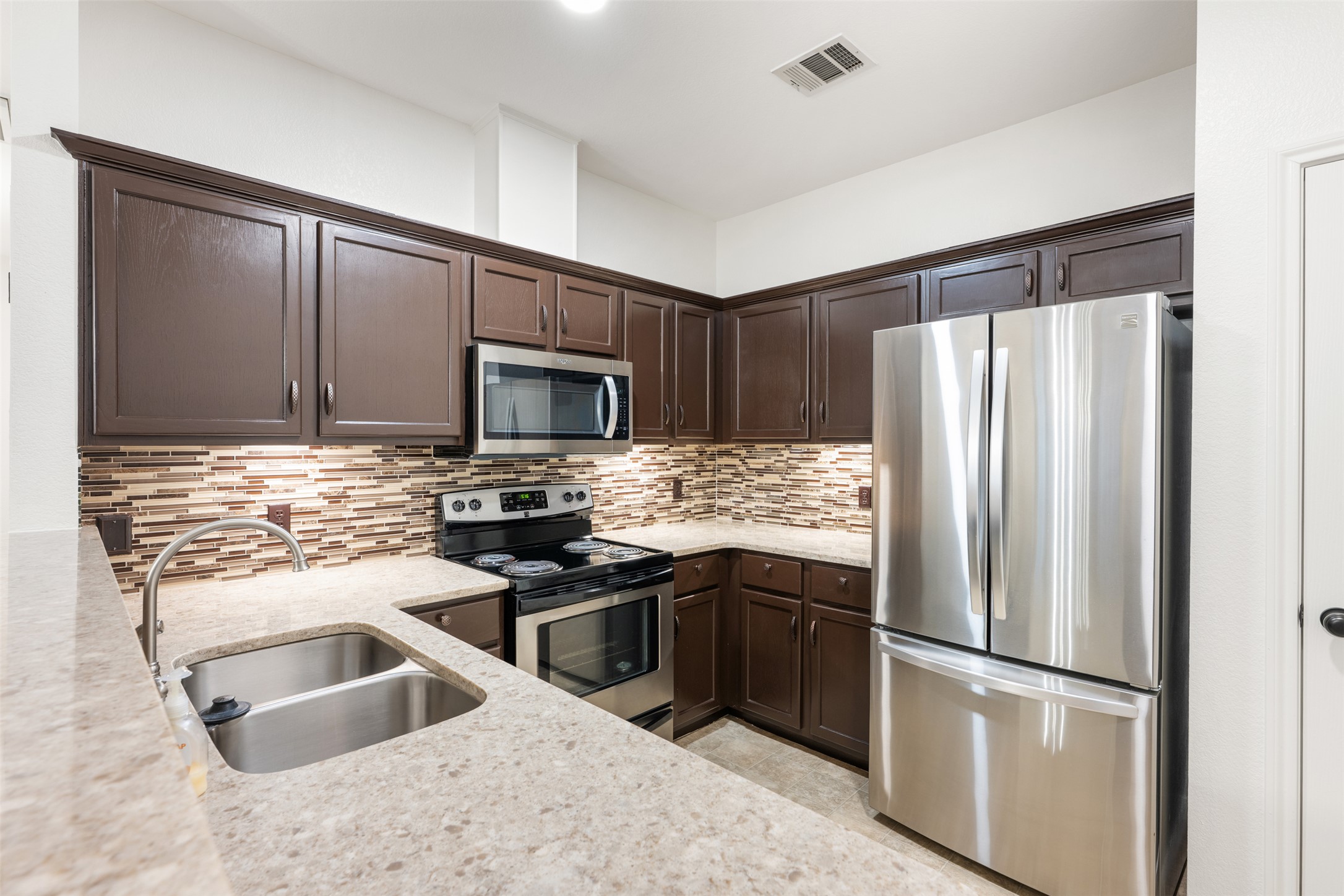 2429 A Curry Loop Round Rock, TX 78664 - Photo 26 of 28 a kitchen with granite countertop stainless steel appliances and refrigerator