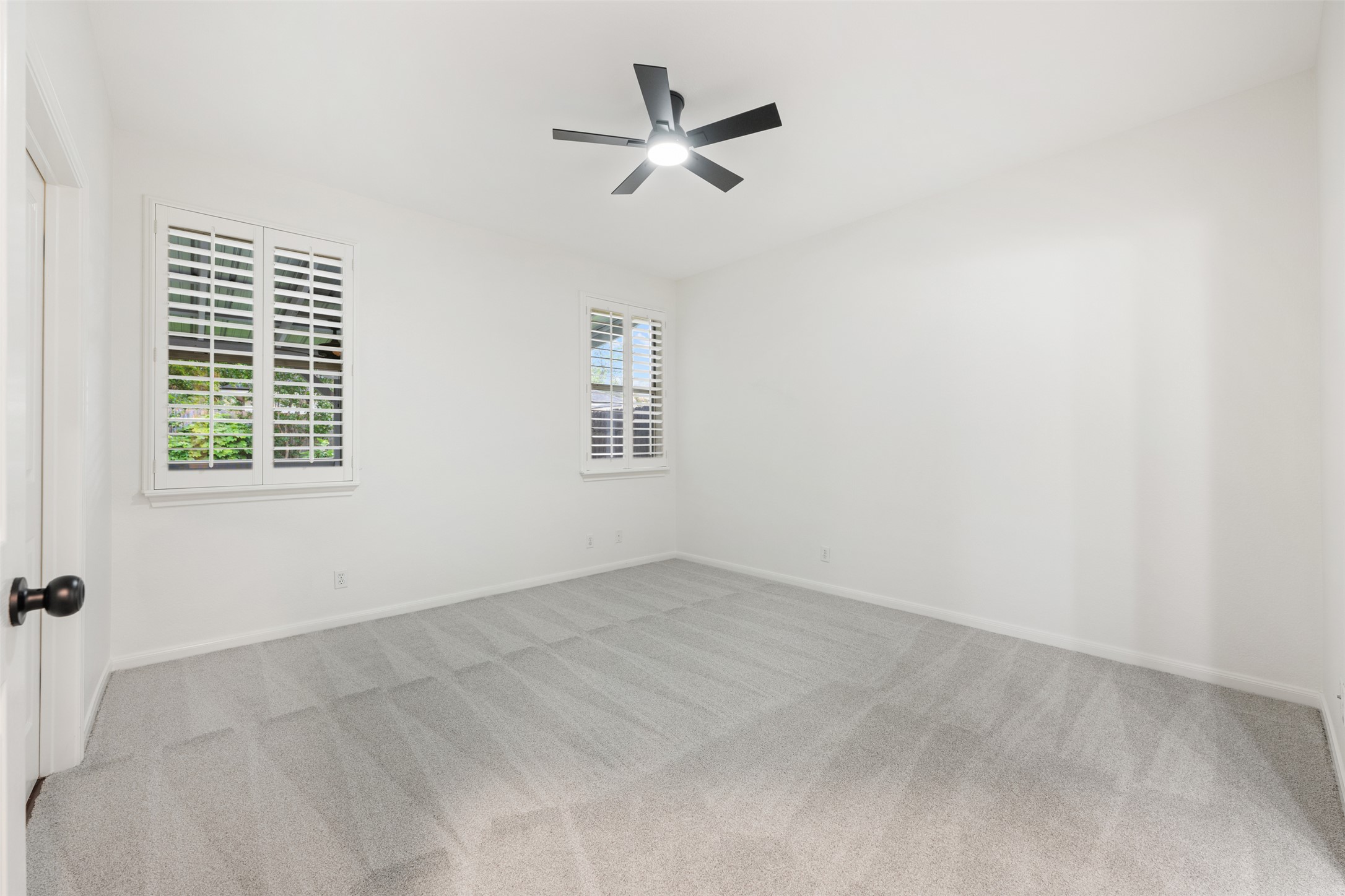 2429 A Curry Loop Round Rock, TX 78664 - Photo 7 of 28 an empty room with ceiling fan and windows