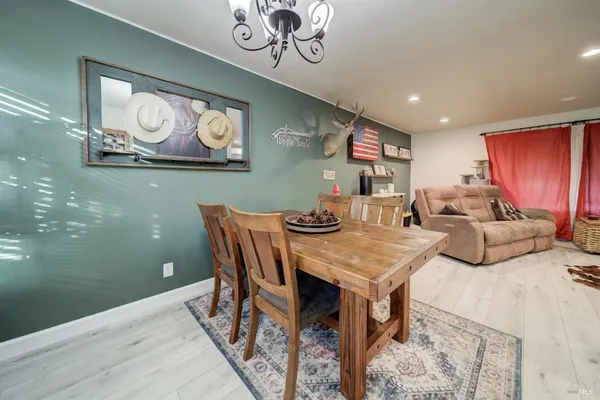 a view of a dining room with furniture and chandelier