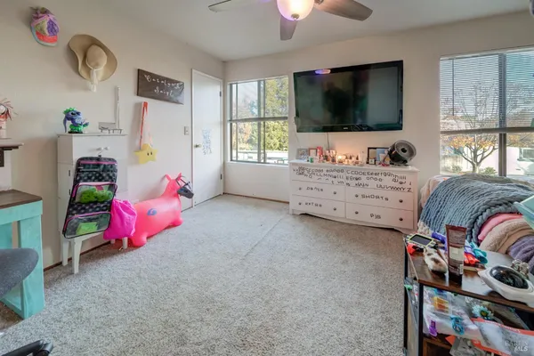 a bedroom with furniture and a flat screen tv
