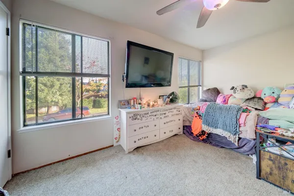 a bedroom with furniture and a flat screen tv