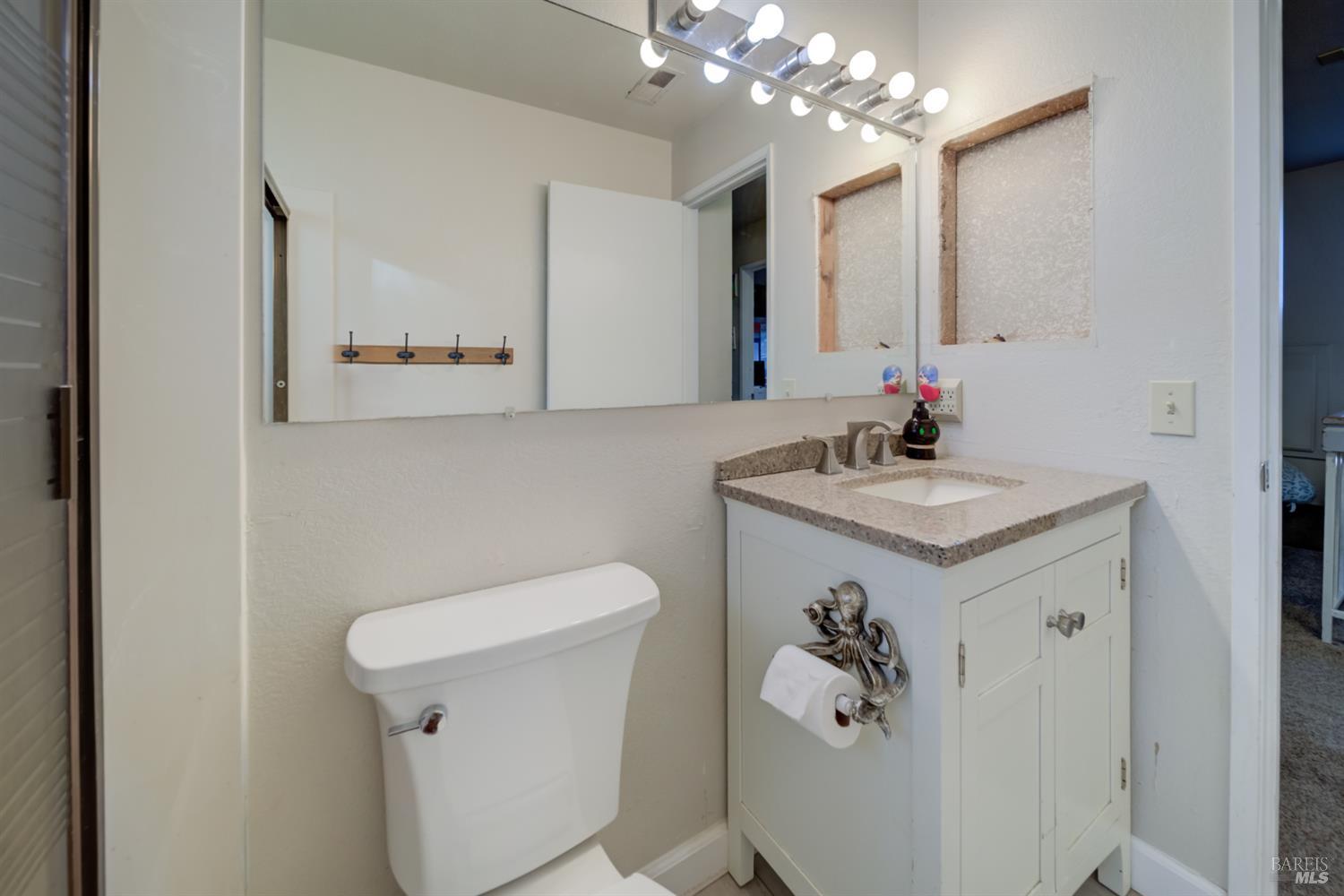 989 Suffolk Way Fairfield, CA 94533 - Photo 21 of 31 a bathroom with a sink a toilet and a mirror