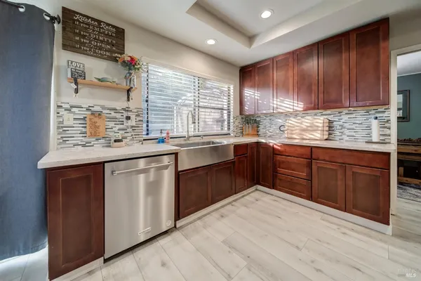 a kitchen with stainless steel appliances granite countertop a refrigerator and a sink