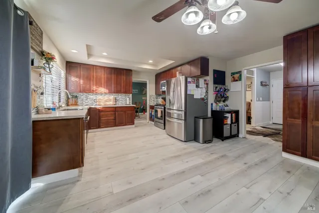 a kitchen with stainless steel appliances and wooden cabinets