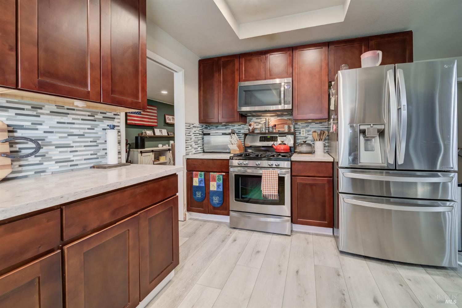 989 Suffolk Way Fairfield, CA 94533 - Photo 5 of 31 a kitchen with stainless steel appliances and wooden cabinets