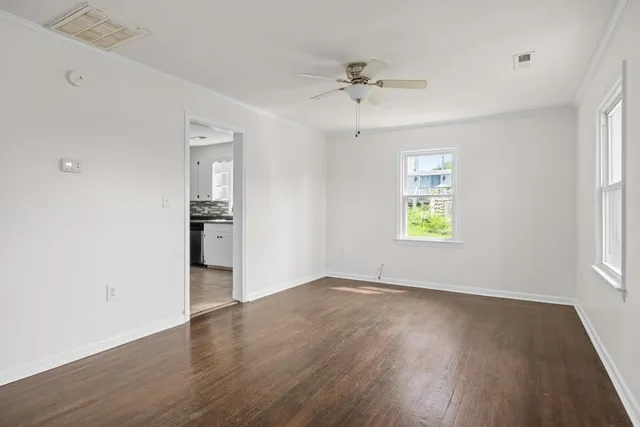 wooden floor in an empty room with a window