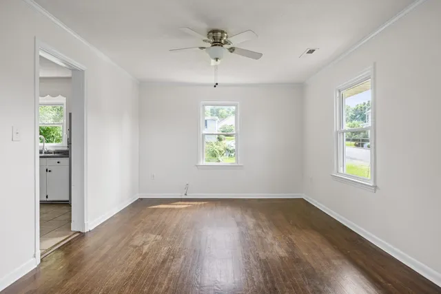 wooden floor in an empty room with a window