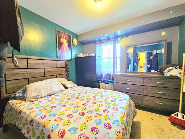 a bedroom with a bed and a dresser