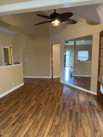 a view of an empty room and wooden floor