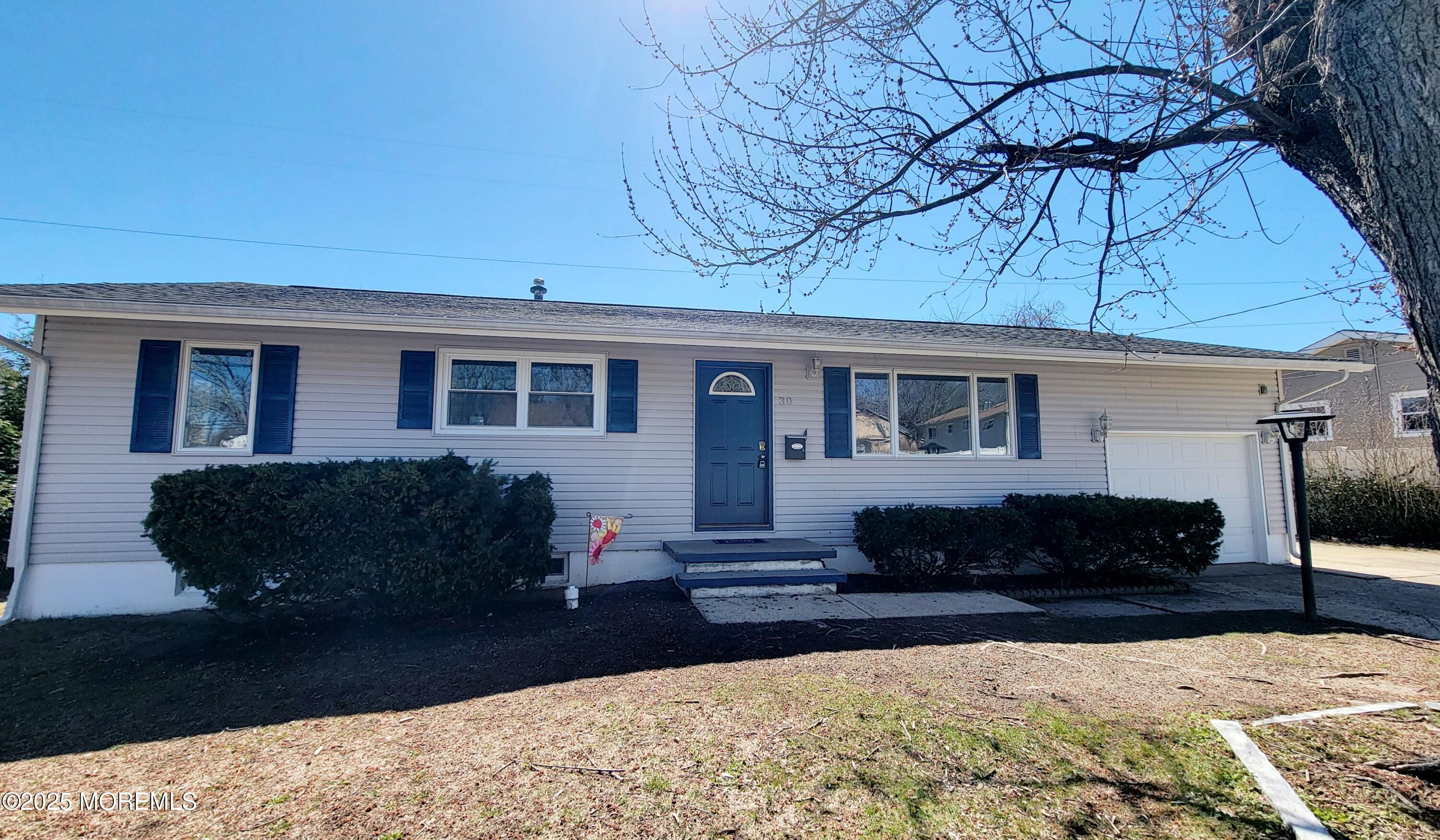 a front view of a house with a yard covered with snow in the outdoor space