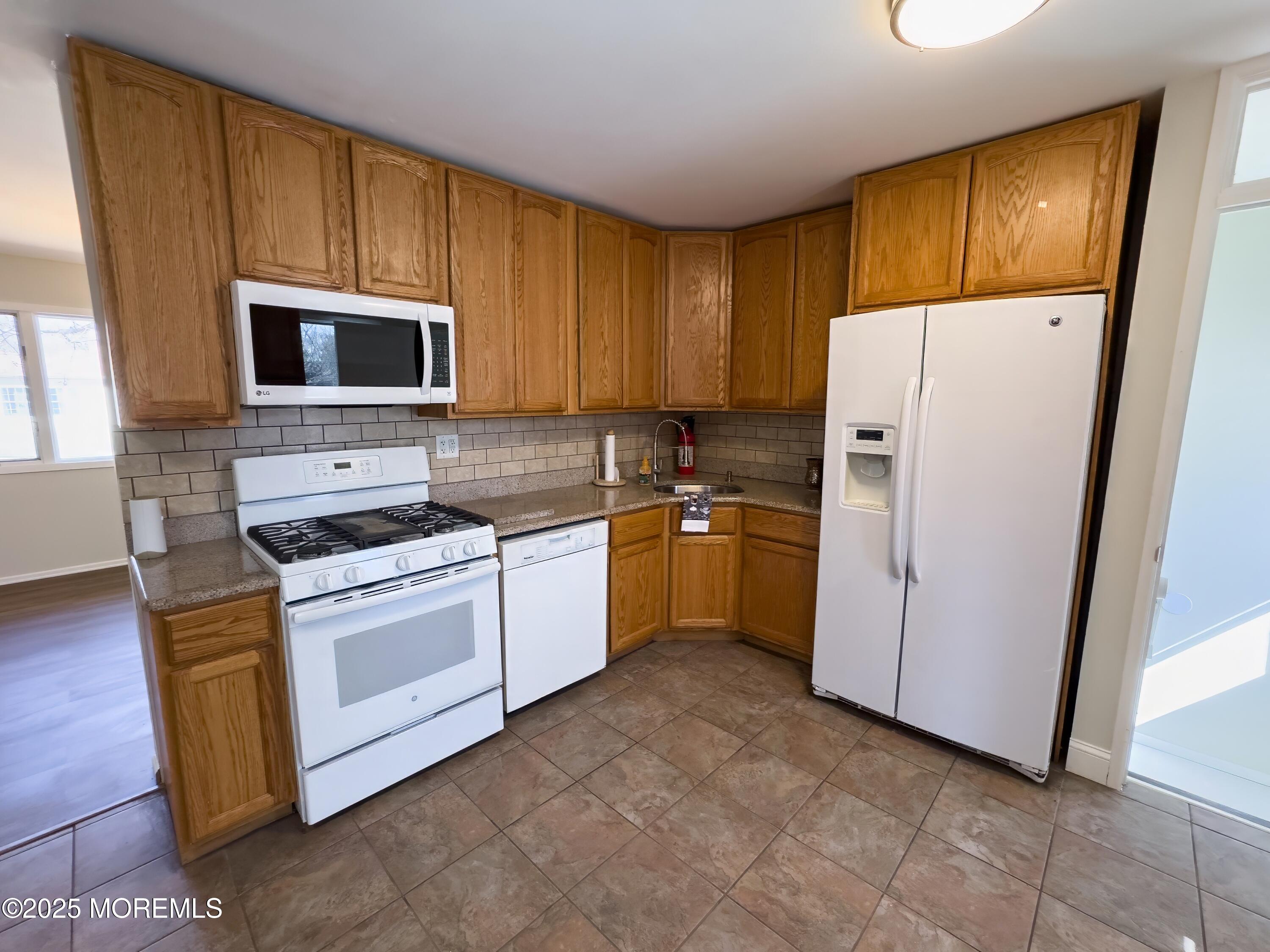 30 Bryant Drive Jackson, NJ 08527 - Photo 12 of 58 a kitchen with a refrigerator stove and microwave
