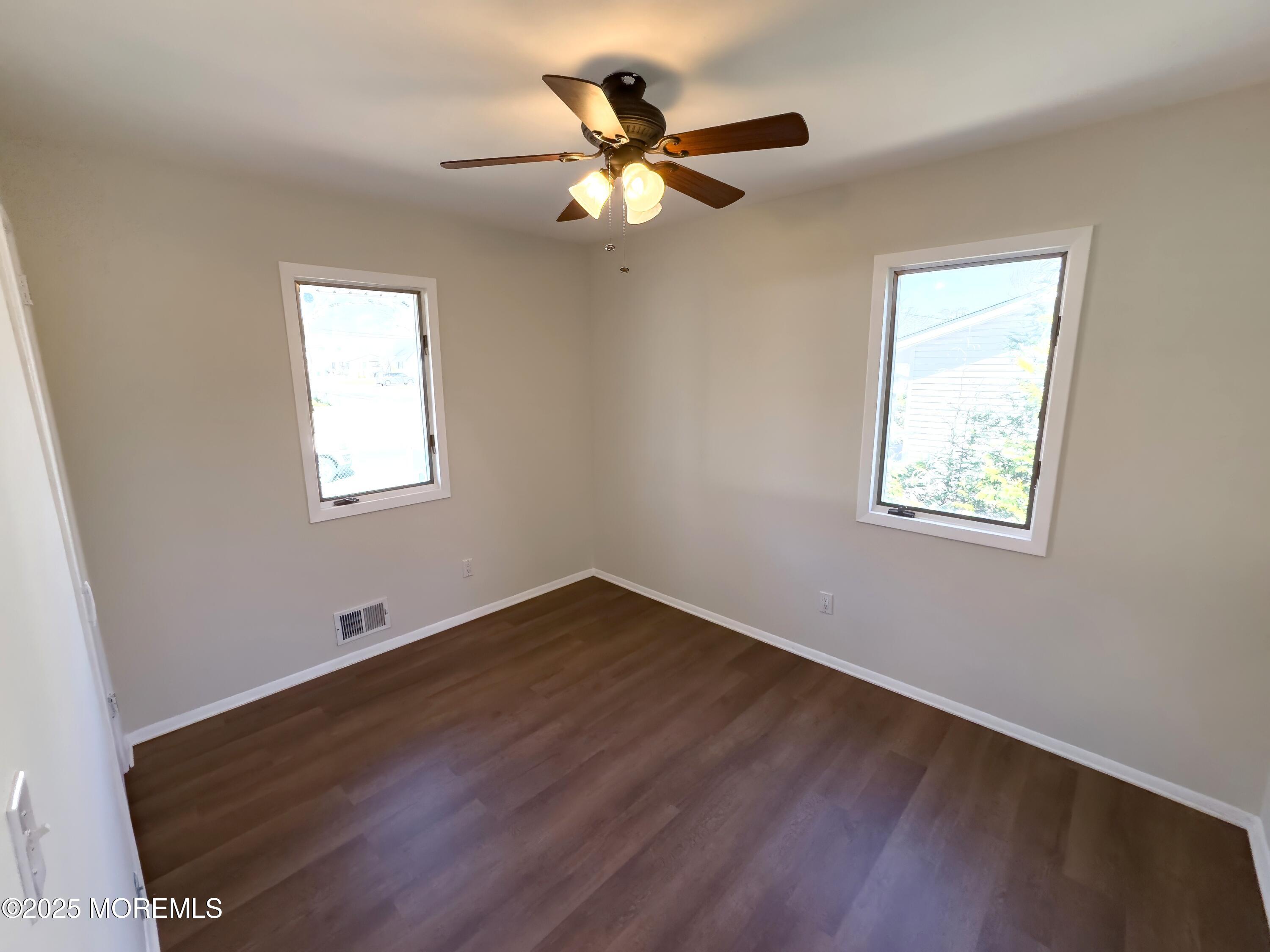 30 Bryant Drive Jackson, NJ 08527 - Photo 20 of 58 a view of an empty room with wooden floor and a window