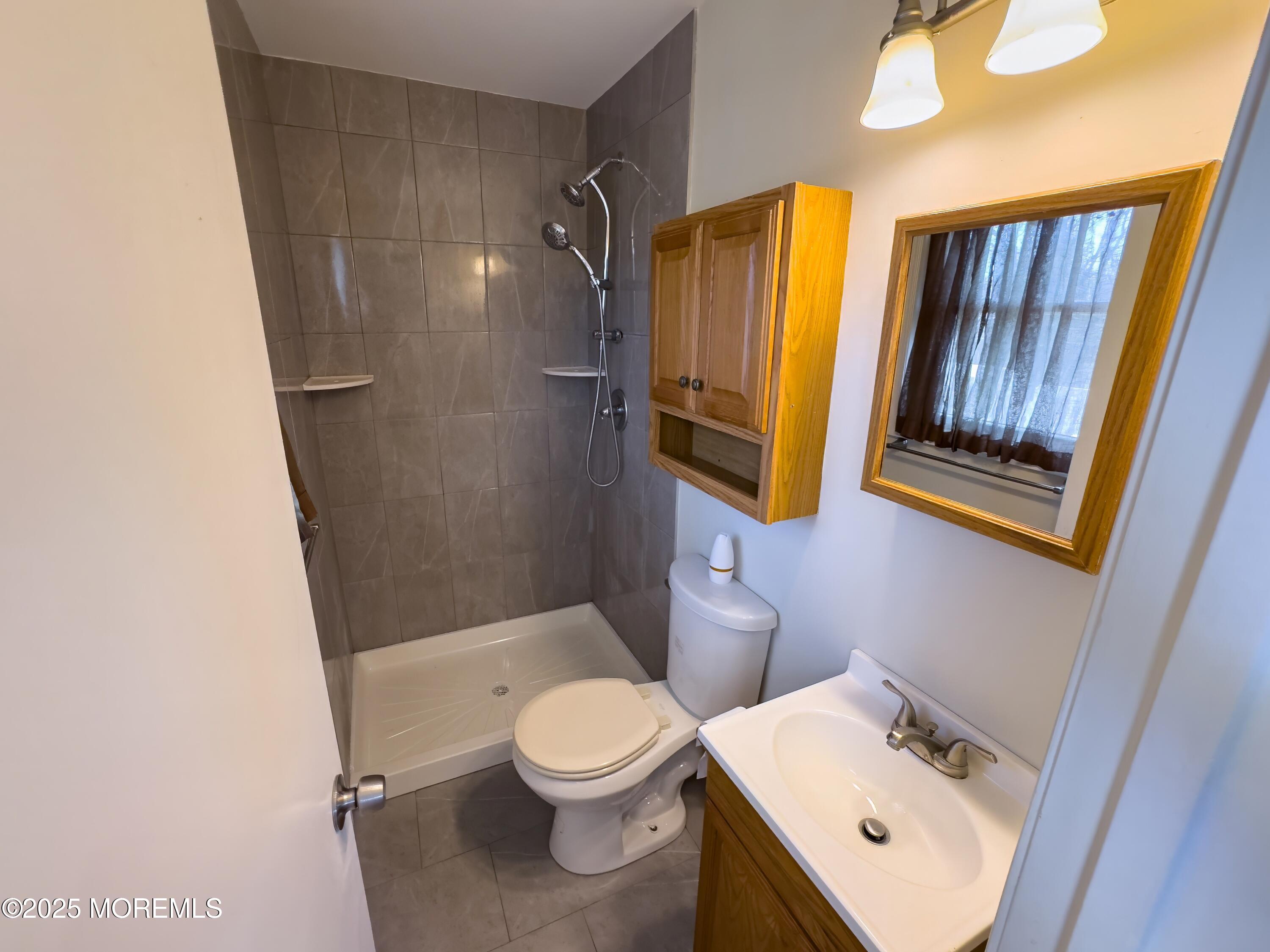 30 Bryant Drive Jackson, NJ 08527 - Photo 25 of 58 a bathroom with a sink and a mirror