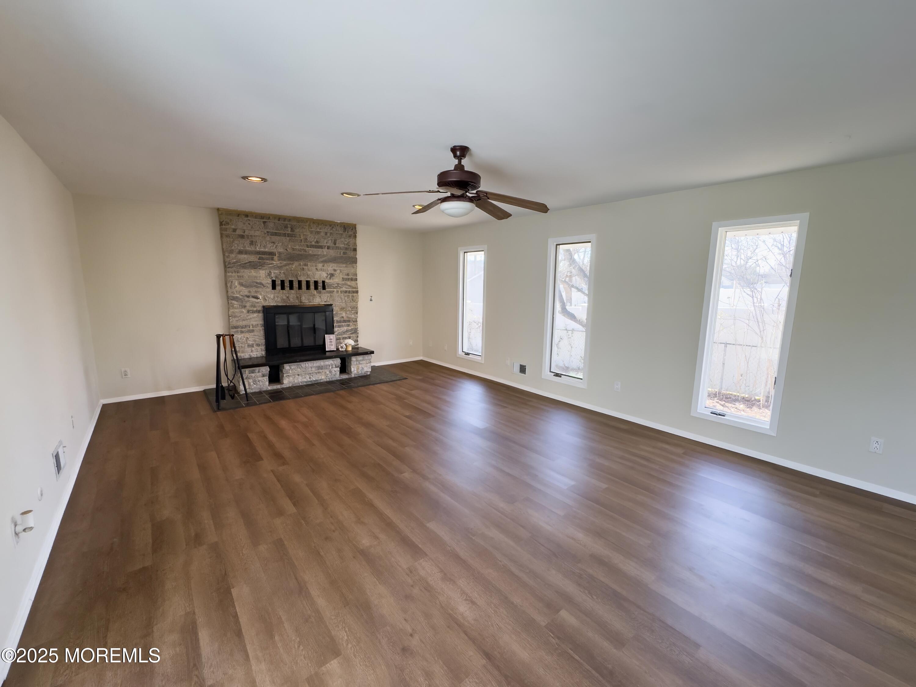 30 Bryant Drive Jackson, NJ 08527 - Photo 30 of 58 a view of a livingroom with wooden floor and a ceiling fan