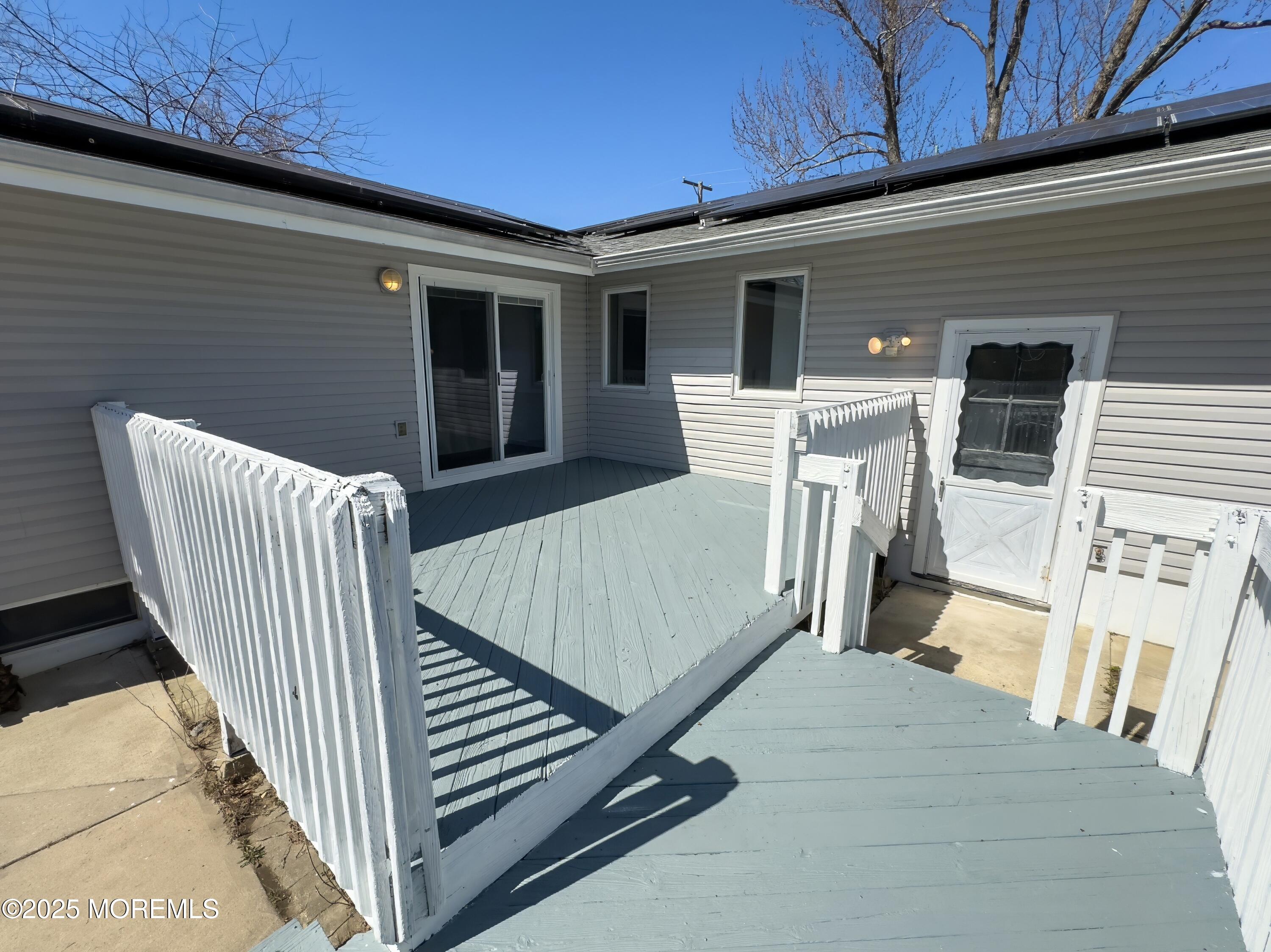 30 Bryant Drive Jackson, NJ 08527 - Photo 47 of 58 a view of a patio with table and chairs with wooden floor and fence