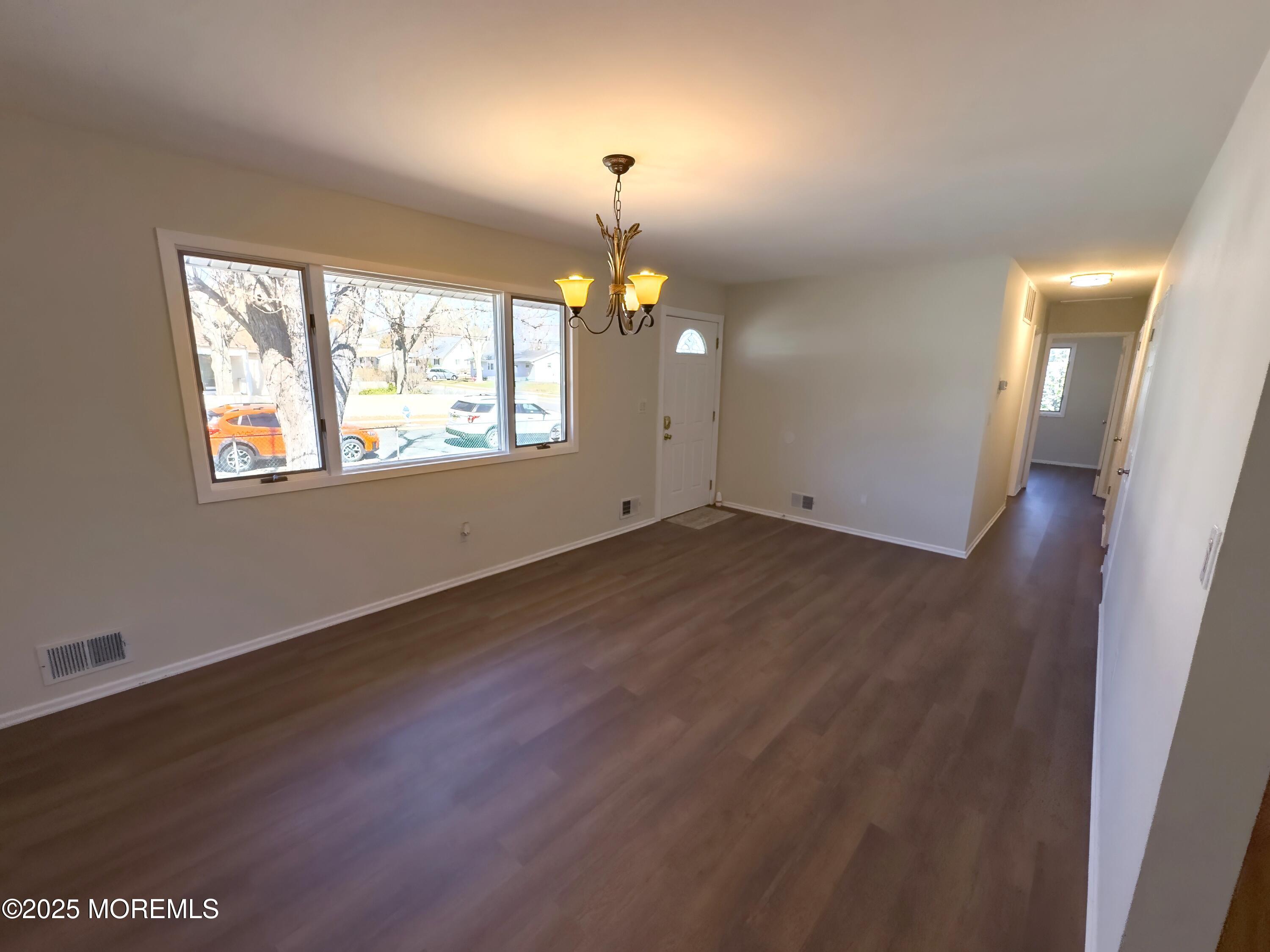30 Bryant Drive Jackson, NJ 08527 - Photo 6 of 58 an empty room with wooden floor and windows