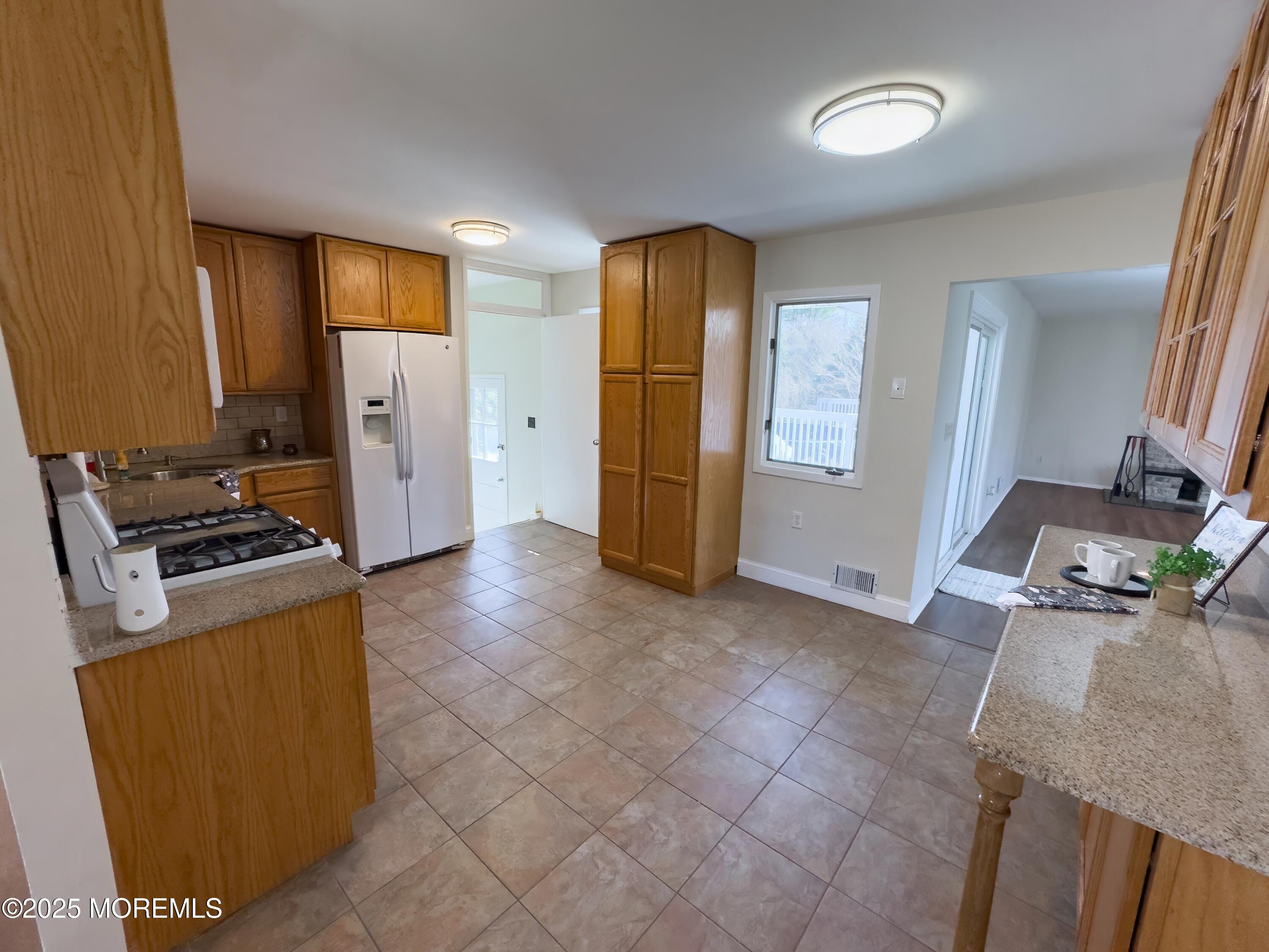 30 Bryant Drive Jackson, NJ 08527 - Photo 9 of 58 a kitchen with stainless steel appliances granite countertop a refrigerator a stove and a sink with granite countertops