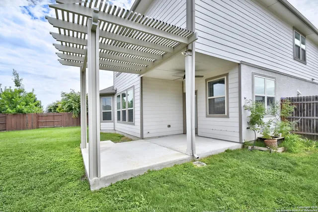 a view of an house with backyard and porch