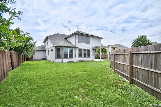 a view of a house with a yard and sitting area
