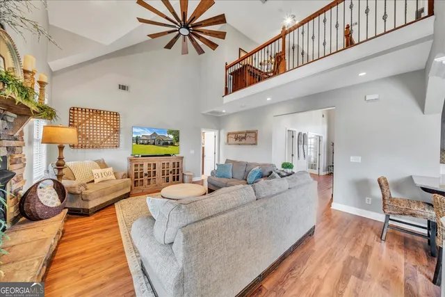 a living room with furniture or wooden floor and a chandelier