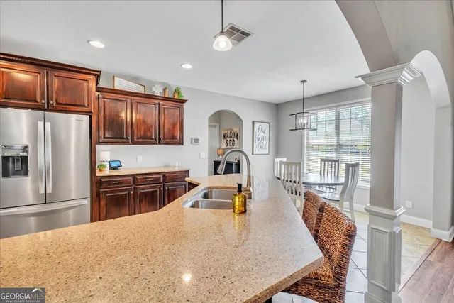 a kitchen with stainless steel appliances granite countertop a sink stove and cabinets