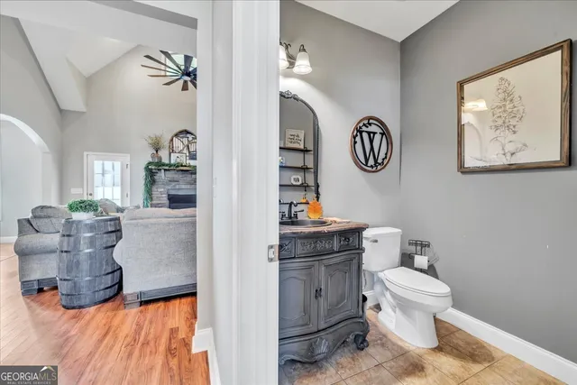 a bathroom with a toilet a sink and a mirror