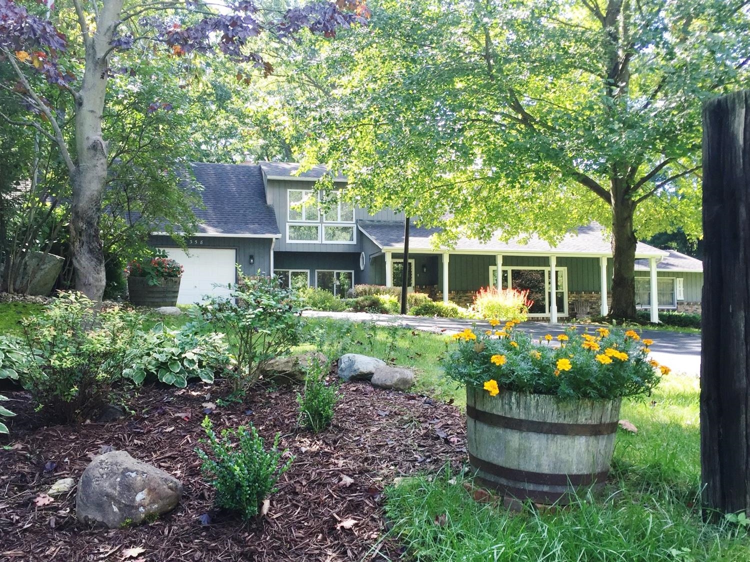 358 West Division Road Valparaiso, IN 46385 - Photo 1 of 10 a front view of a house with a garden and fountain