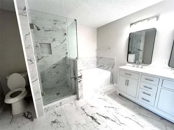 a bathroom with a sink mirror toilet and shower