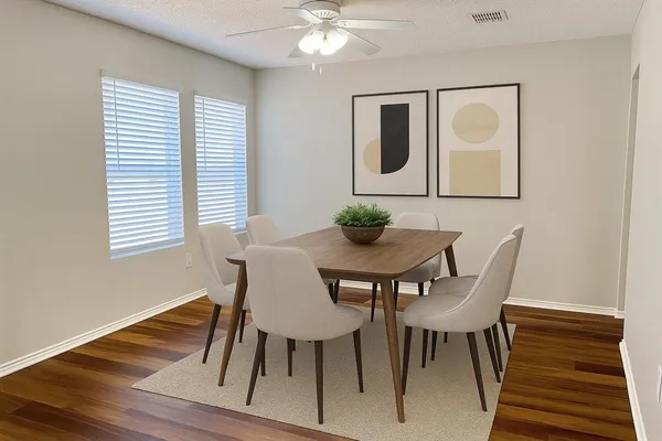 a dining room with furniture and window