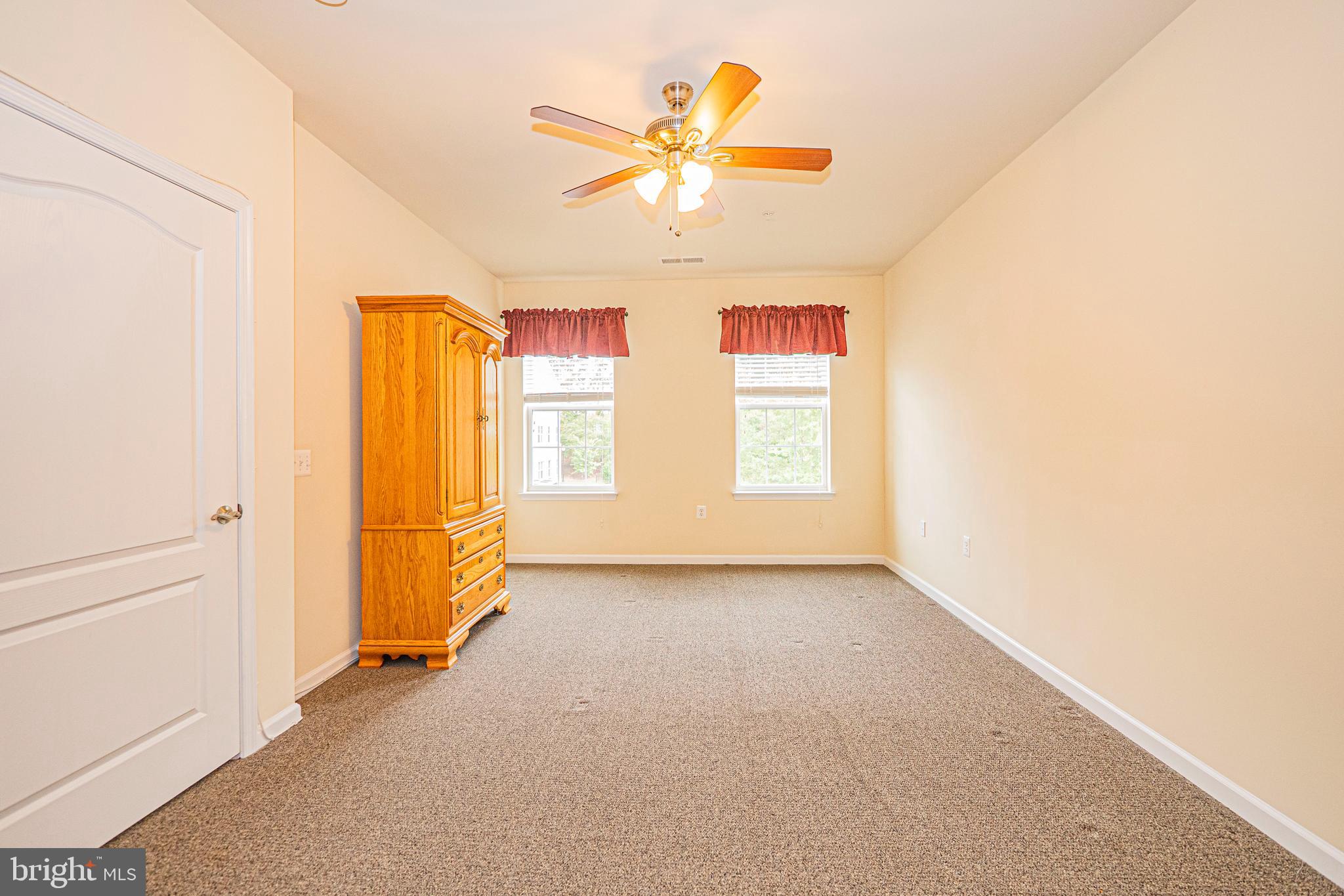 1405 Wigeon Way, Unit 206 Gambrills, MD 21054 - Photo 13 of 29 an empty room with window and ceiling fan