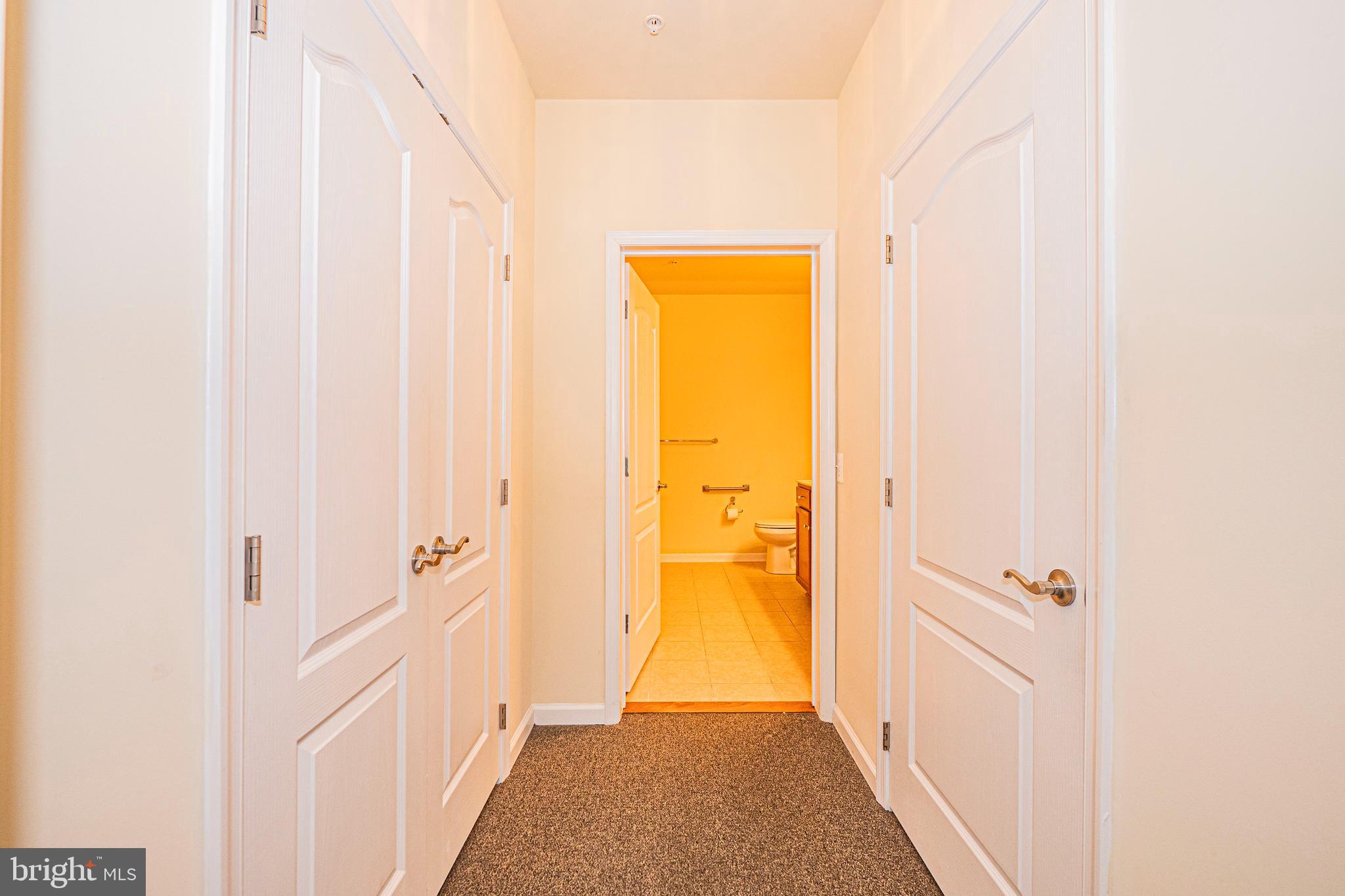 1405 Wigeon Way, Unit 206 Gambrills, MD 21054 - Photo 16 of 29 a view of a hallway with wooden floor