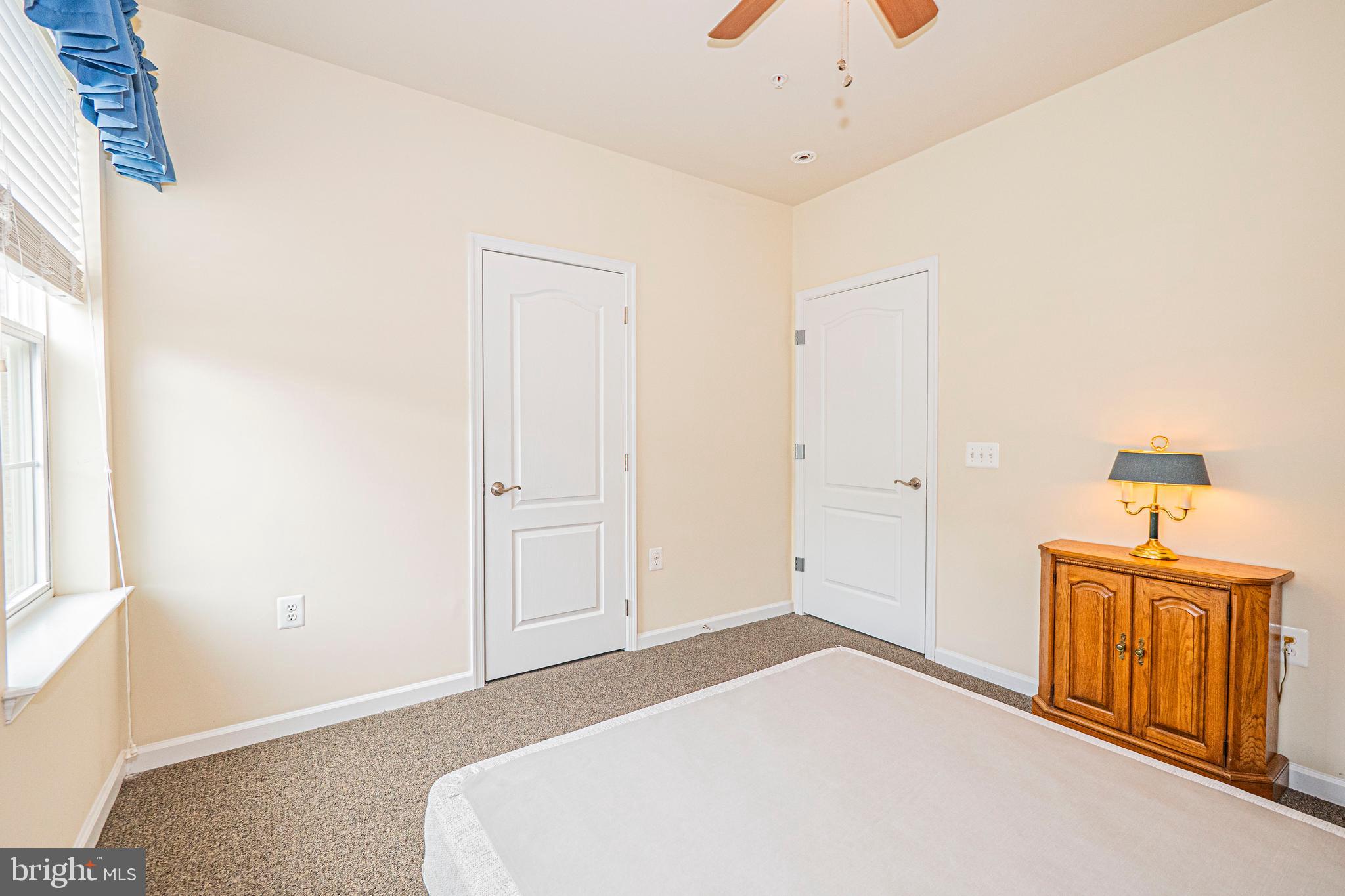 1405 Wigeon Way, Unit 206 Gambrills, MD 21054 - Photo 22 of 29 a bedroom with a bed and a window
