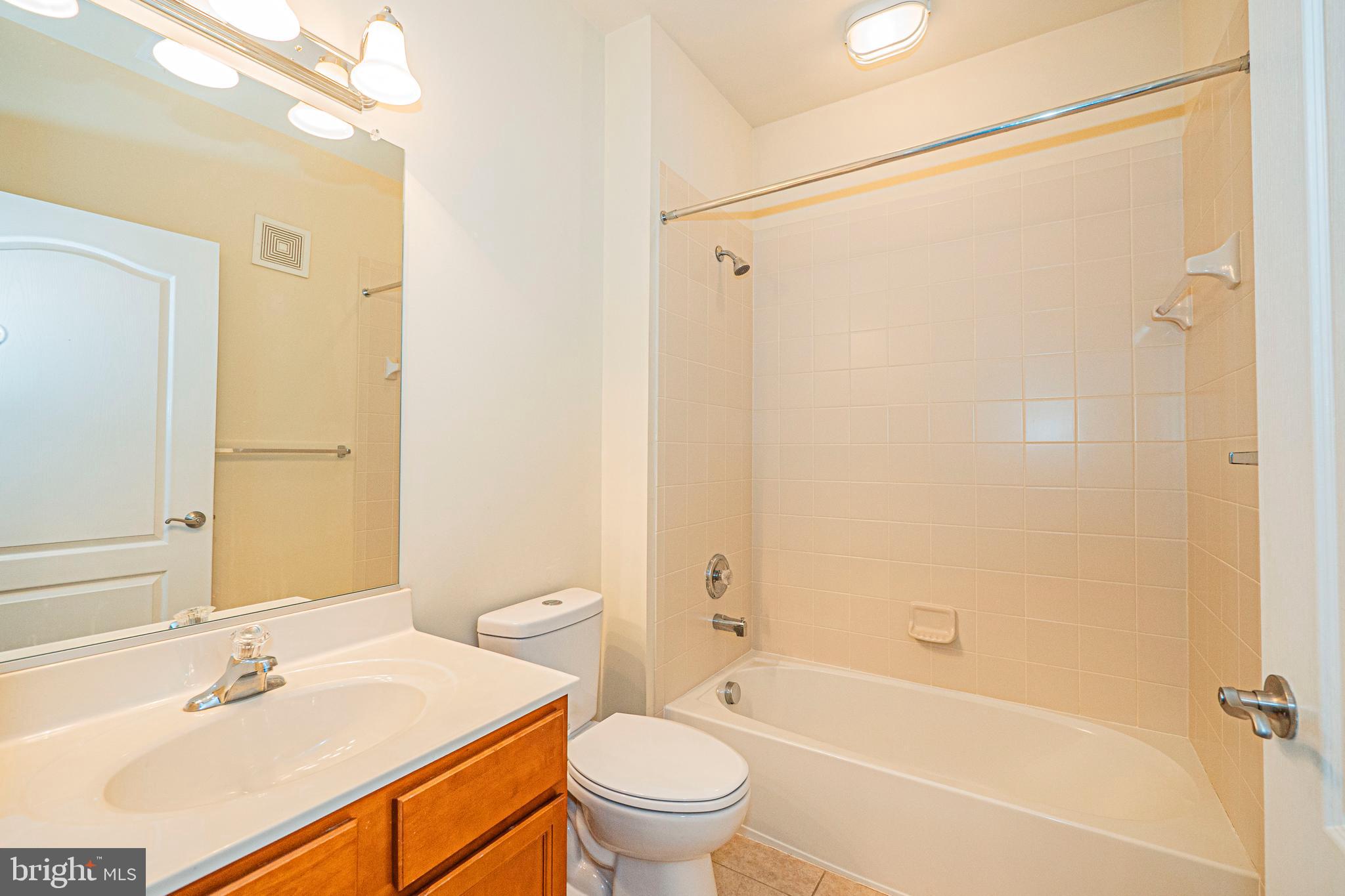 1405 Wigeon Way, Unit 206 Gambrills, MD 21054 - Photo 23 of 29 a bathroom with a sink a toilet and shower