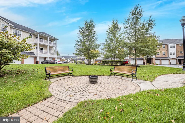 a white bench sitting in middle of garden