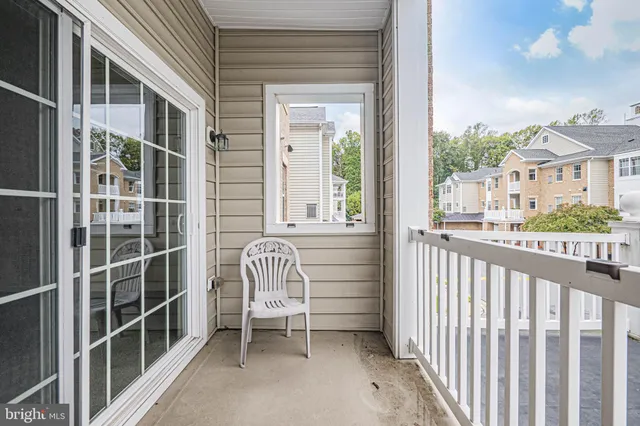 a view of a chair and table in the balcony