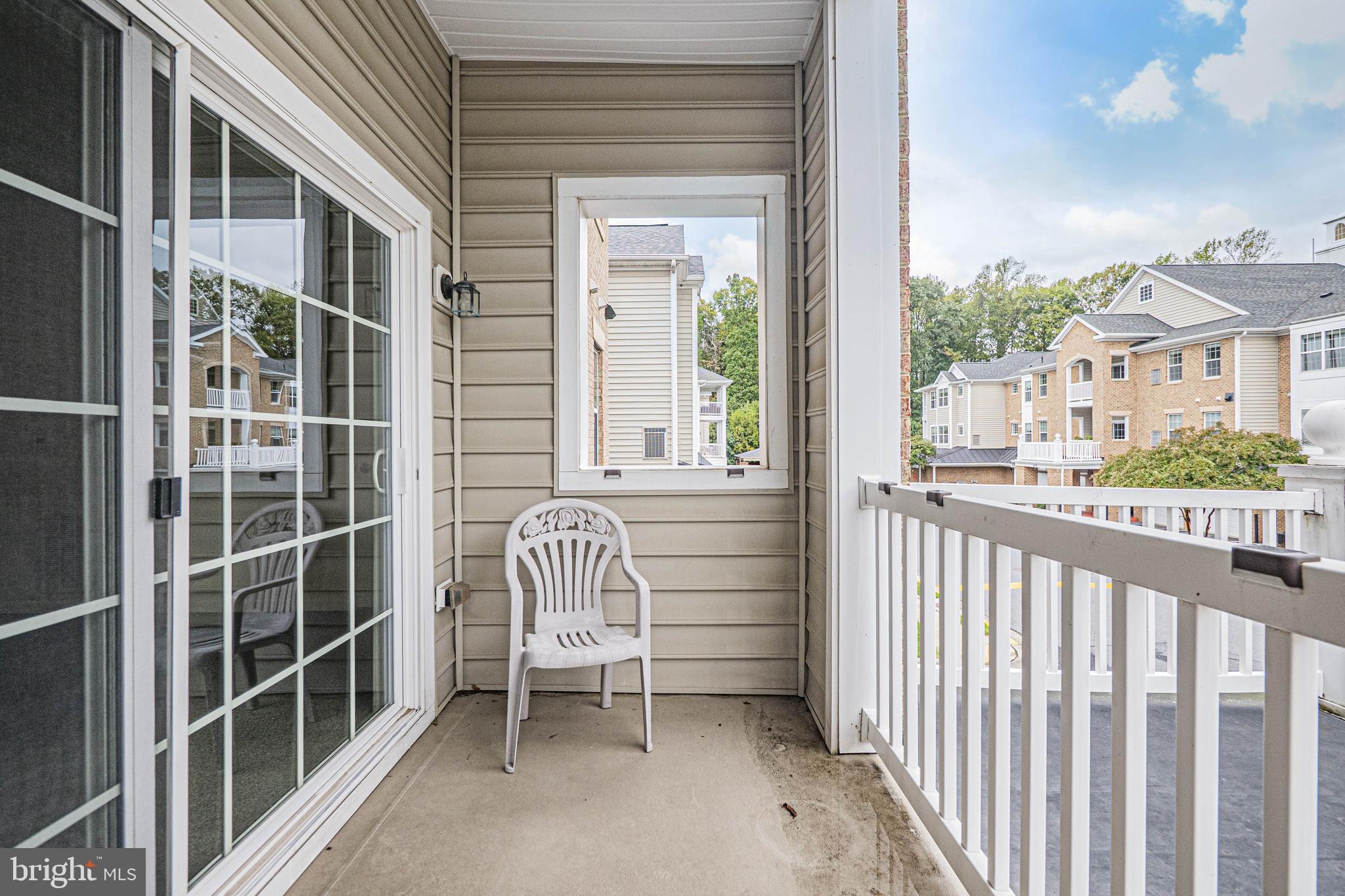 1405 Wigeon Way, Unit 206 Gambrills, MD 21054 - Photo 8 of 29 a view of a chair and table in the balcony
