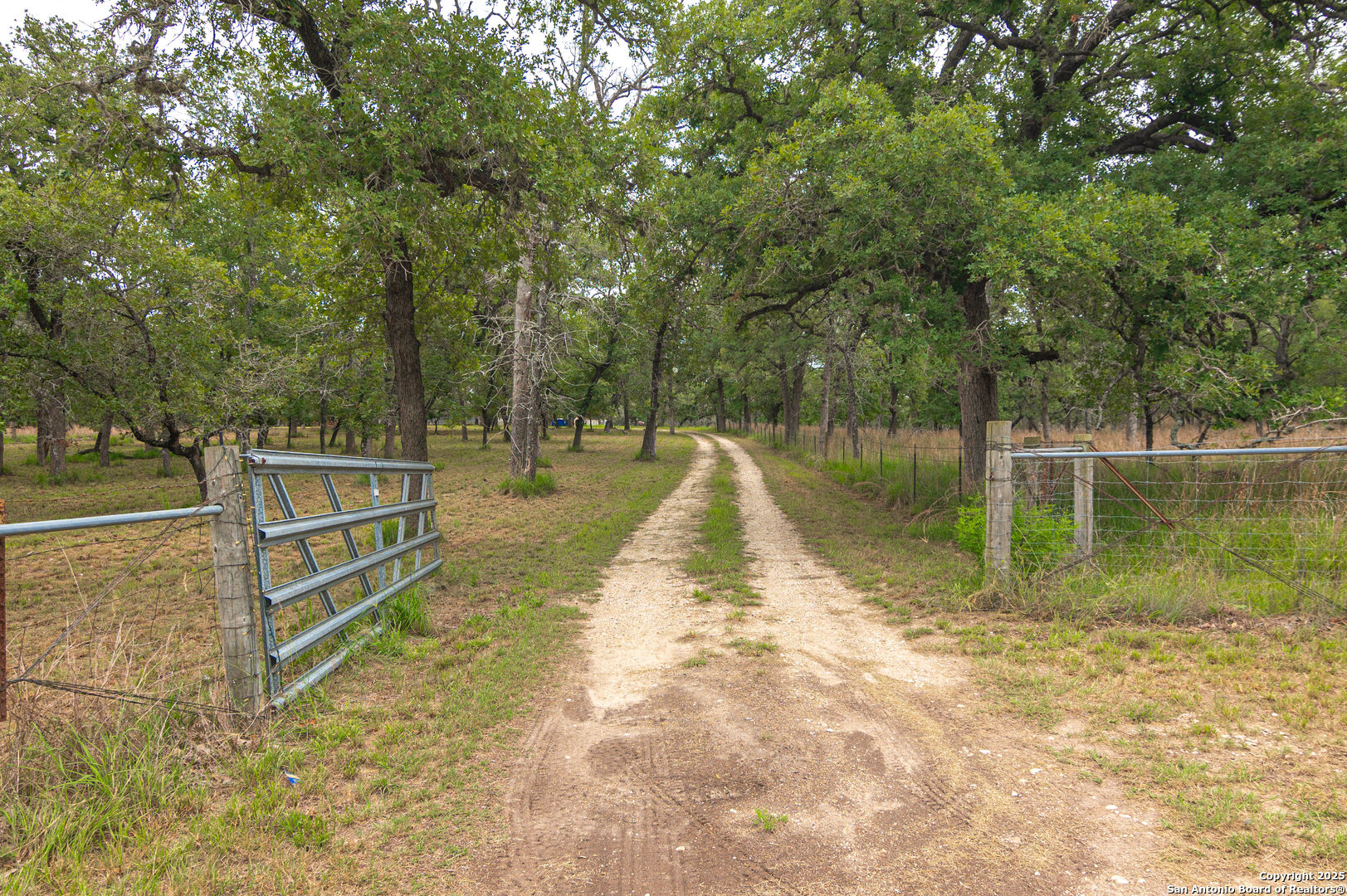 2981 Vivroux Ranch Road Seguin, TX 78155 - Photo 47 of 50 a view of a lake with a wooden fence