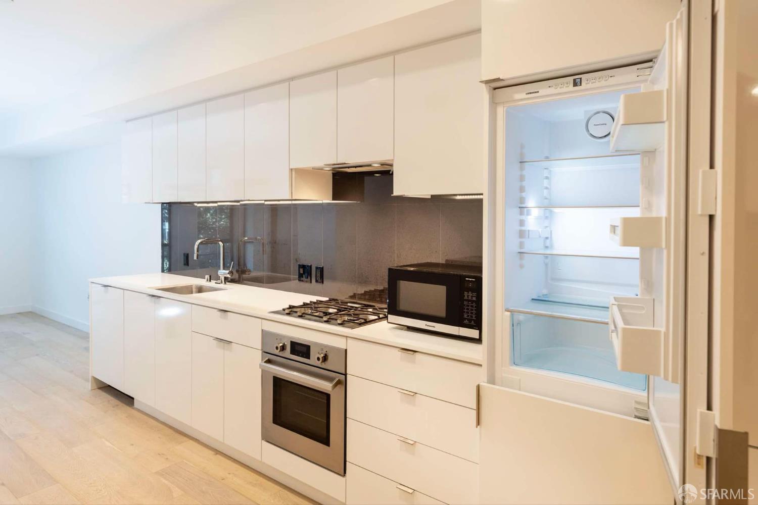 99 Rausch Street, Unit 303 San Francisco, CA 94103 - Photo 4 of 37 a kitchen with a stove and a microwave