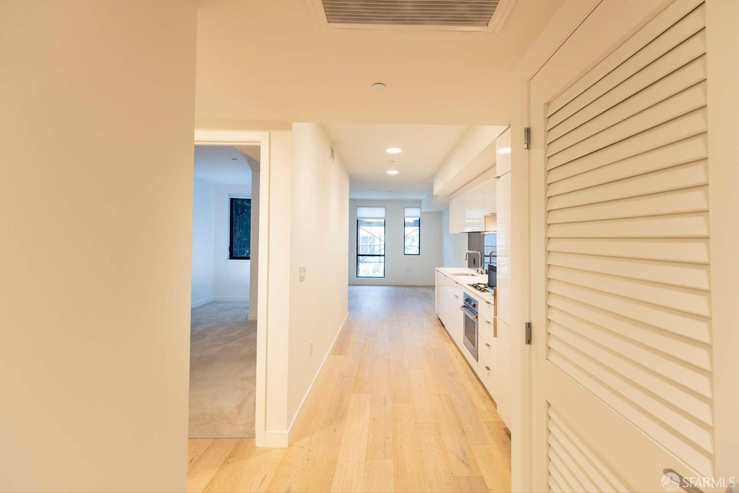 99 Rausch Street, Unit 303 San Francisco, CA 94103 - Photo 8 of 37 a view of a hallway with a kitchen
