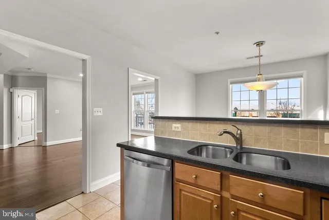a kitchen with a sink cabinets and window
