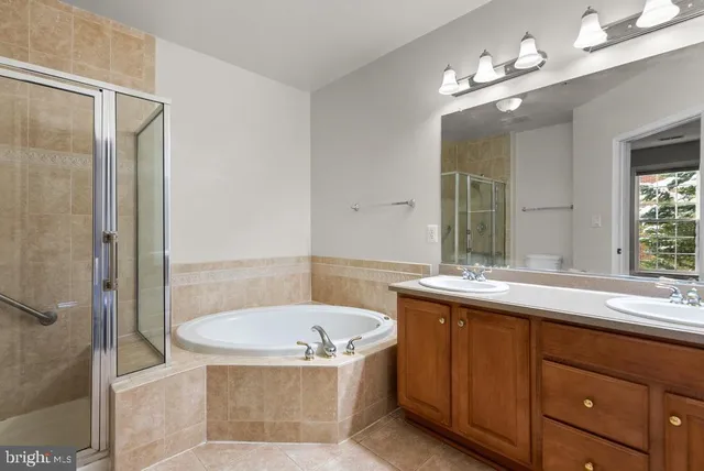 a bathroom with a tub sink and mirror