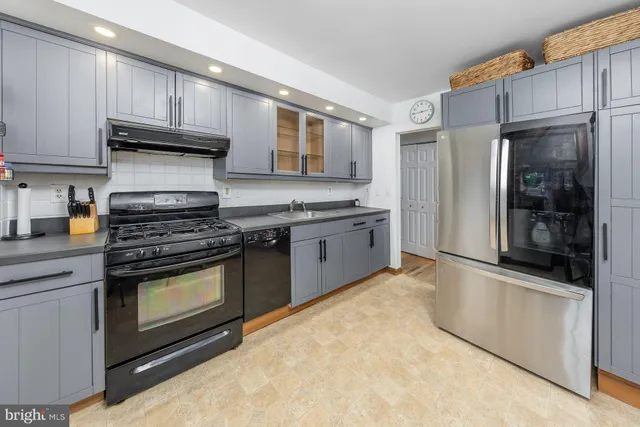 a kitchen with stainless steel appliances granite countertop a stove and a refrigerator